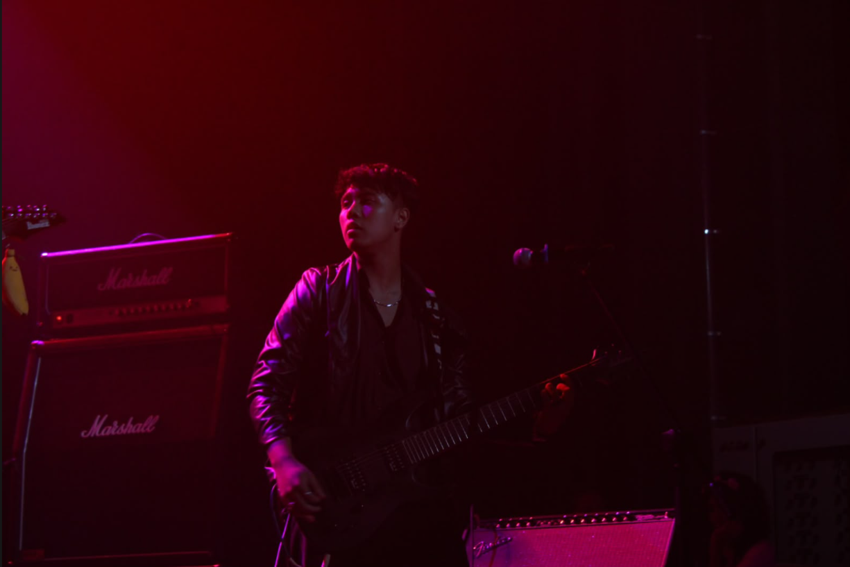 Tashi Bhutia performing on stage with guitar